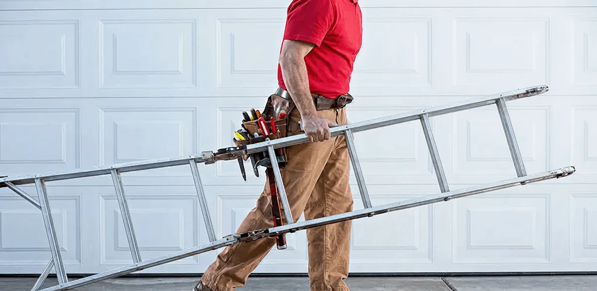 Garage door repair technician arriving with tools and ladder in Clearwater, FL