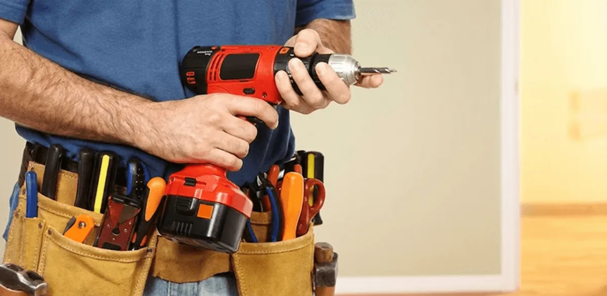 Handyman holding a power drill for home repairs and installations in Clearwater, FL